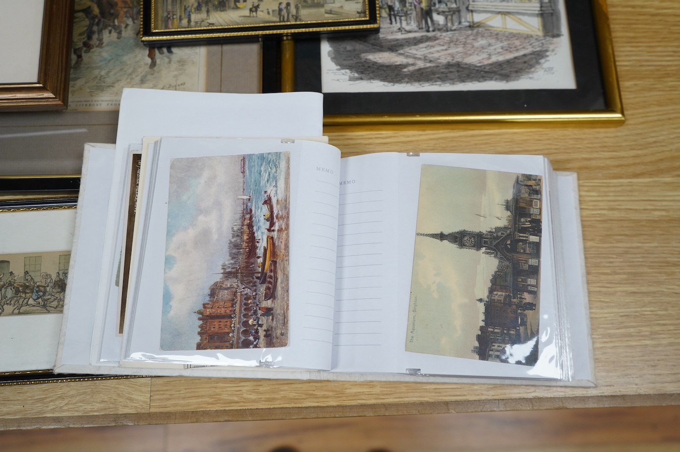 A collection of Brighton prints and engravings to include Mahomeds Baths, Brighton and London Safety Coach, St Nicholas Church and The Block House, largest 20 x 21cm, (12), together with postcard album, mostly Brighton s